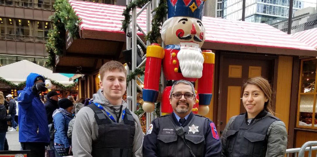 Interns and Officer in front of giant nutcracker