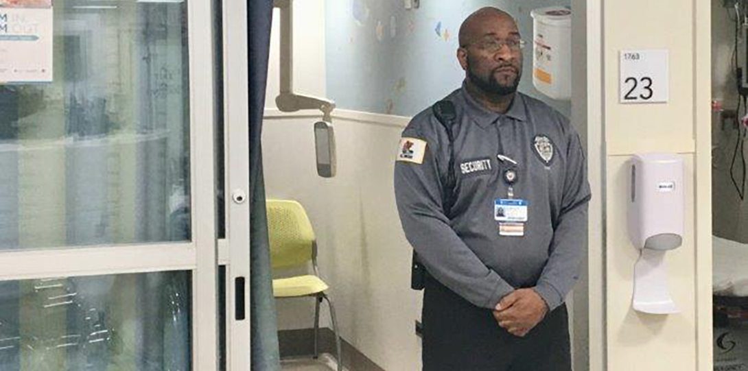 Security officer outside a patient room